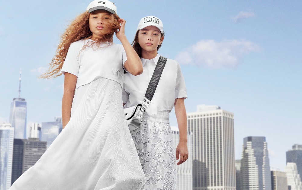 2 girls in white DKNY outfits. Trendy white and black caps 2024 DKNY on Kids around